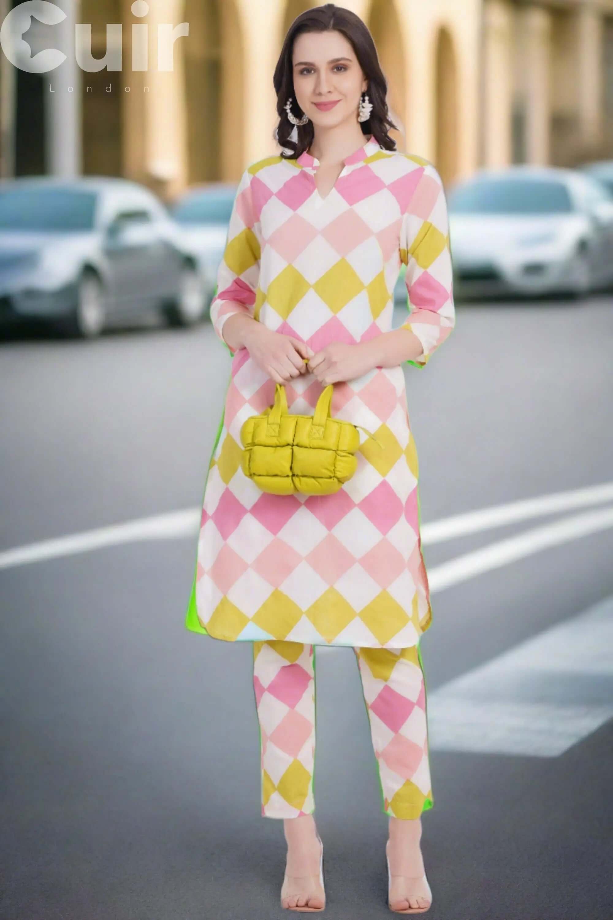 Woman in colorful geometric outfit holding a small lime green leather crossbody bag on the street.