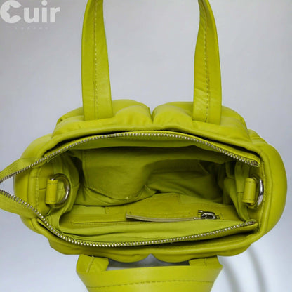 Interior view of small lime green leather crossbody bag with zippered compartment, showcasing stylish compact design.