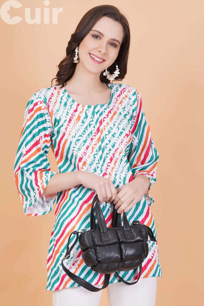 Woman in colorful striped top holding a black genuine leather crossbody bag with adjustable strap.